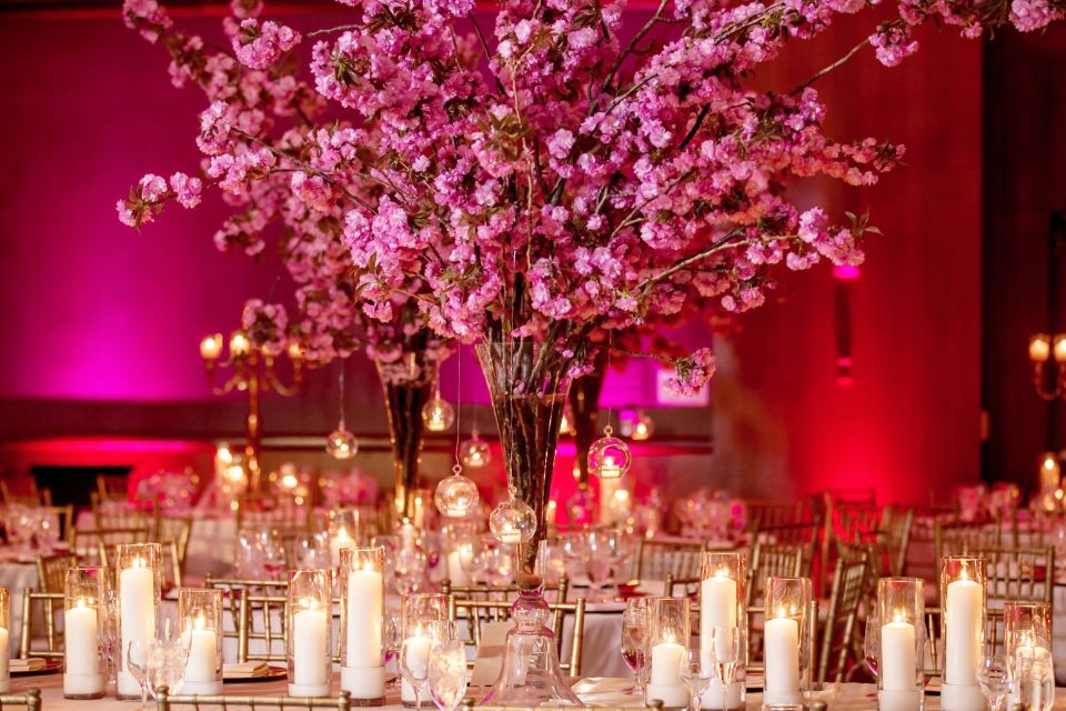 Cherry blossom and candle table decorations at an asian wedding